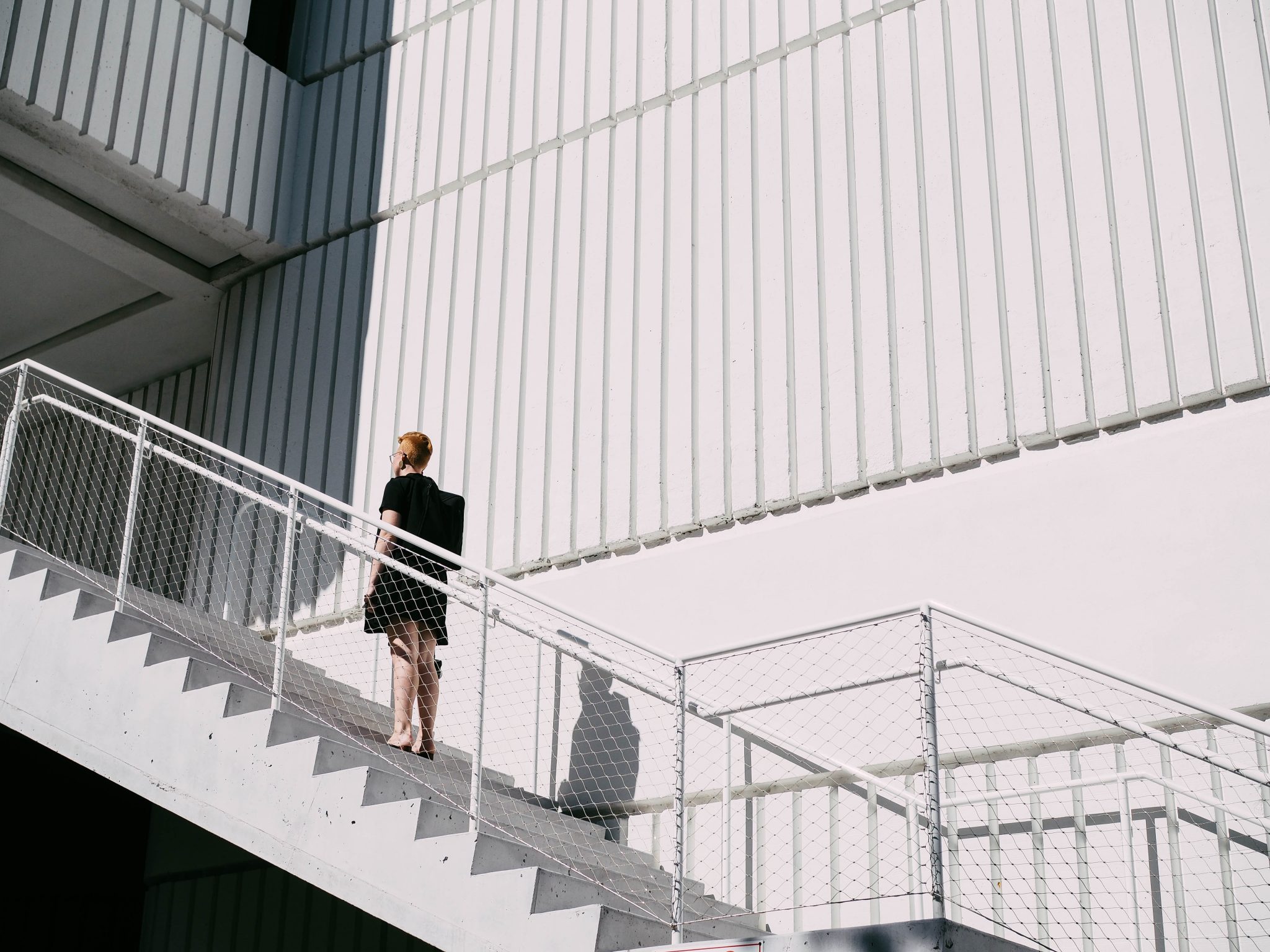 woman standing on stairway during daytime