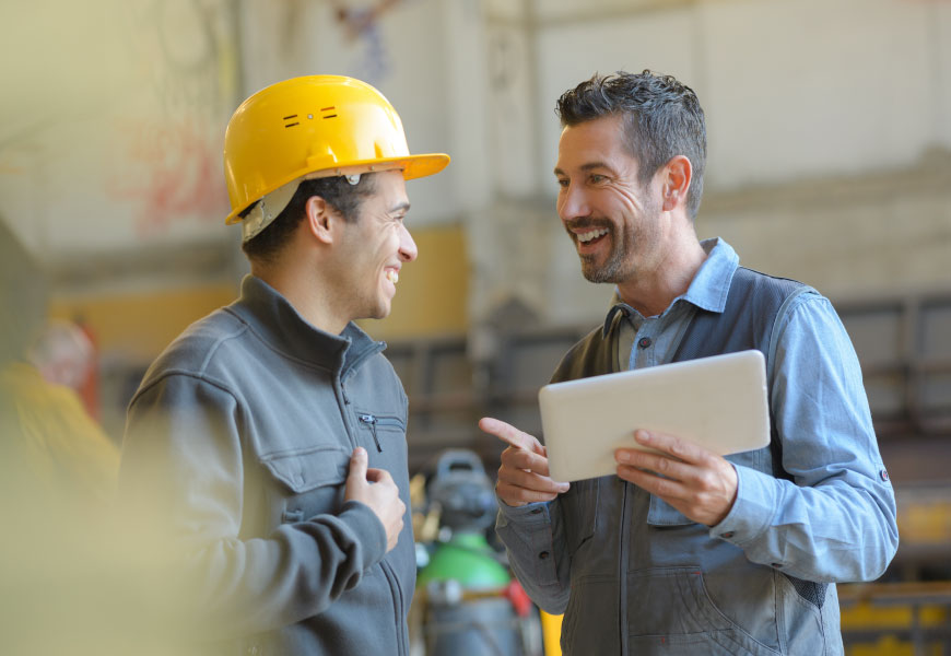 Manufacturing workers talking to eachother