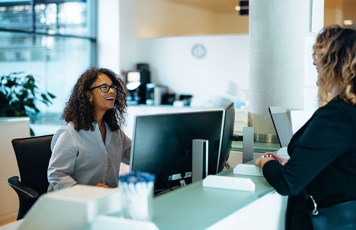 worker talking with woman Banker showing paperwork to woman