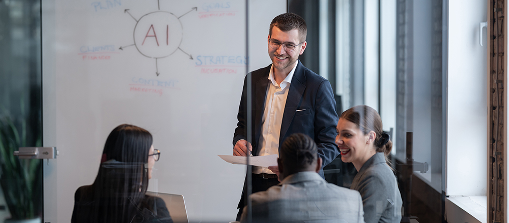 Diverse business team in a modern office during a meeting, discussing artificial intelligence strategy. Concept of AI innovation, teamwork, leadership, corporate planning, professional collaboration Unraveling a Culture of Fear to Help Reduce Workplace Anxiety