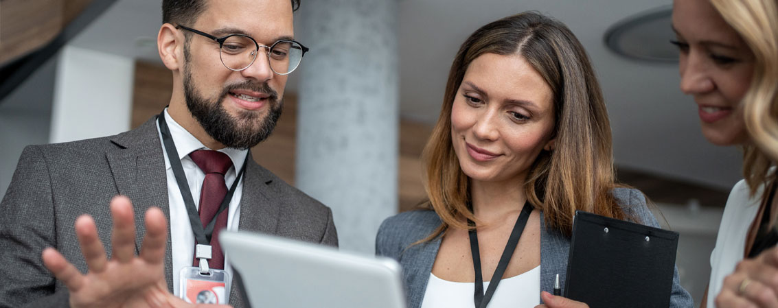 Business professionals looking at a device
